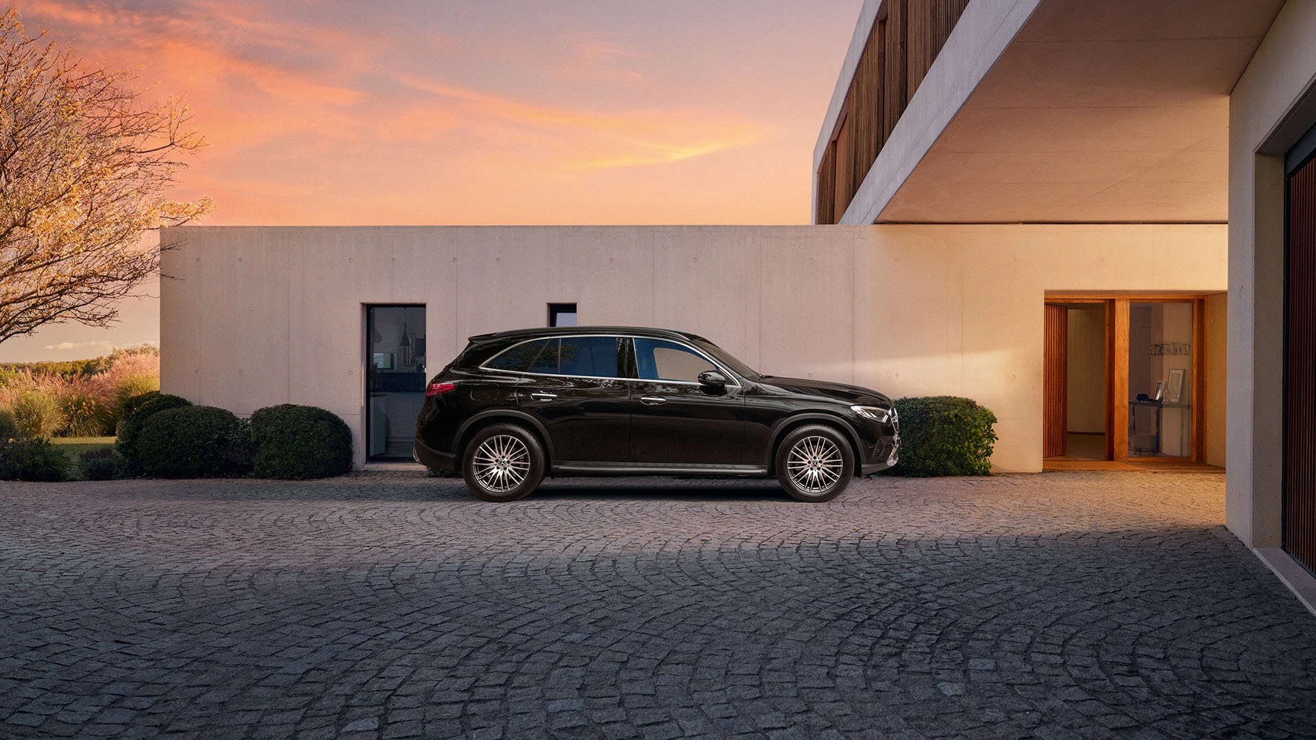 Musta Mercedes-Benz GLC talon edessä.